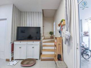 Cozy living room with staircase and television set