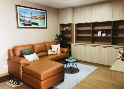 Cozy living room with leather sofa and wooden furniture