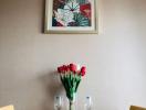 Elegantly set table in a dining room with floral wall art and fresh flowers