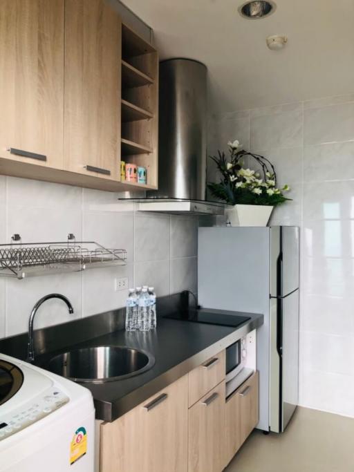 Modern kitchen with stainless steel appliances and wooden cabinetry