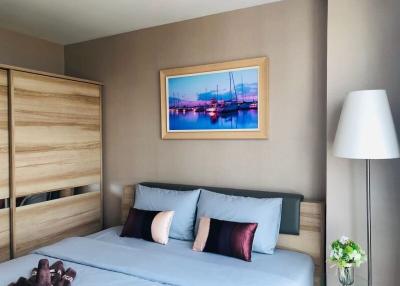 Cozy bedroom with a comfortable bed, wooden wardrobe, and decorative wall art