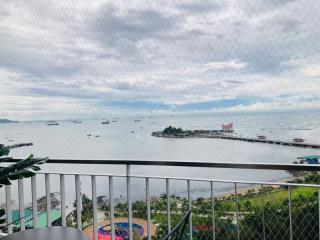 Scenic view from balcony overlooking the sea with ships and a small island