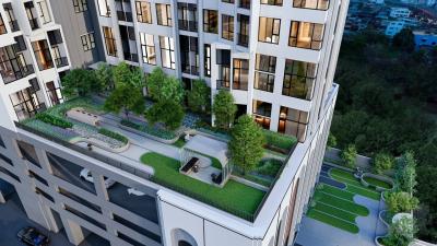 Luxury apartment building exterior with landscaped rooftop garden at dusk