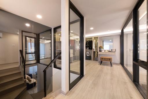 Modern entryway in a residential home with staircase and large glass doors