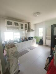 Spacious kitchen with white cabinetry and modern appliances