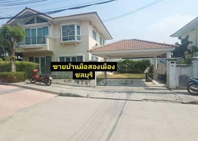 Two-story residential house with an open gate and a scooter parked outside