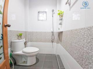 Modern bathroom with white fixtures and gray tiles