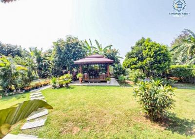 Peaceful garden setting with gazebo and lush greenery