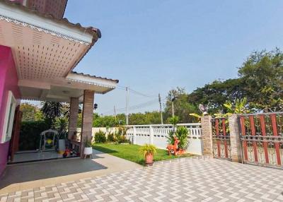 Spacious home exterior with patterned paving and gated entrance
