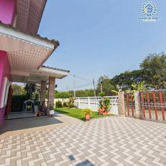 Spacious home exterior with patterned paving and gated entrance