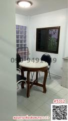 Cozy dining area with a round table and chairs by the window