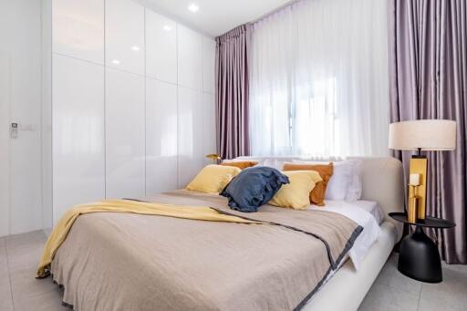 Modern bedroom with a large comfortable bed and elegant interior decoration