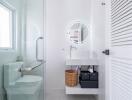 Modern bathroom with clean white design, illuminated mirror, and a glass shower