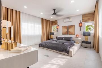 Spacious and modern bedroom with ample lighting and elegant decor