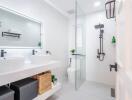 Modern bathroom with double vanity and glass shower enclosure