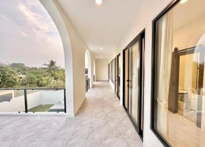 Spacious balcony with a view, featuring large sliding doors and modern railing