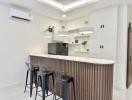 Modern kitchen with breakfast bar and pendant lighting