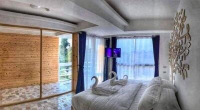 Modern bedroom with balcony access and mounted TV