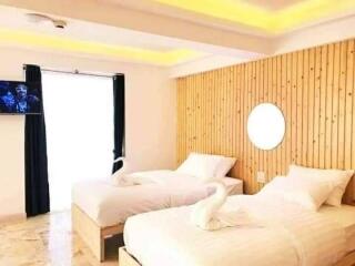 Modern Bedroom with Twin Beds and Wooden Accent Wall