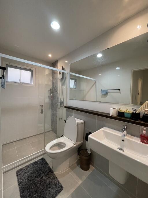 Modern spacious bathroom with shower and large mirror