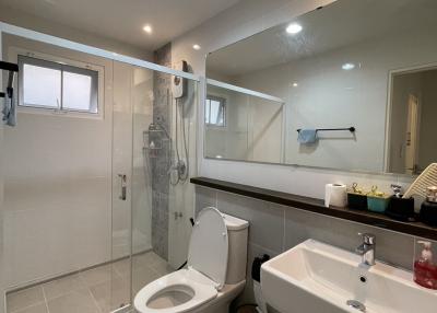 Modern spacious bathroom with shower and large mirror