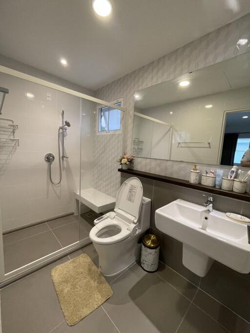 Modern bathroom interior with walk-in shower and white fixtures