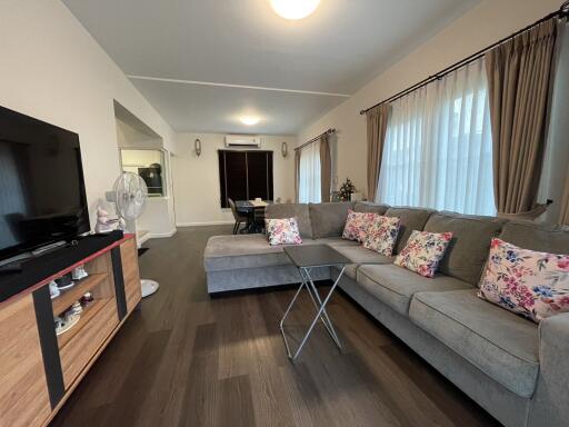 Spacious living room with modern furnishings and natural lighting