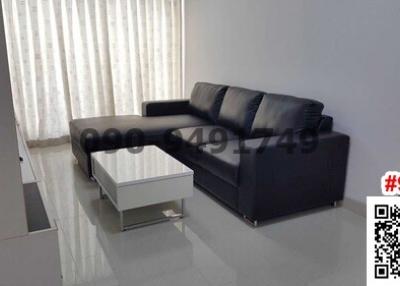 Modern living room with a black leather sofa and clean design