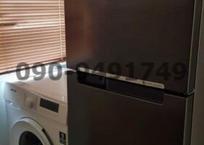 Samsung washing machine and refrigerator in a home utility space