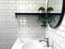 Modern bathroom with white subway tiles and round mirror