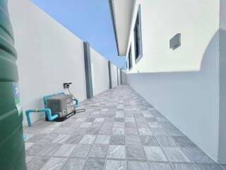 Paved side passage of a residential building with high walls