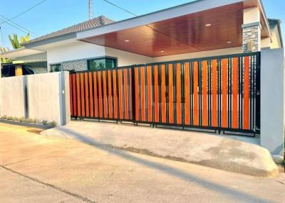 Modern house facade with stylish gate and driveway
