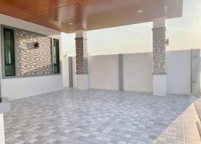 Spacious tiled patio with stone-clad columns and wooden ceiling