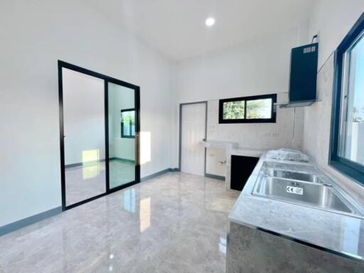 Modern kitchen with stainless steel sink and marble countertops