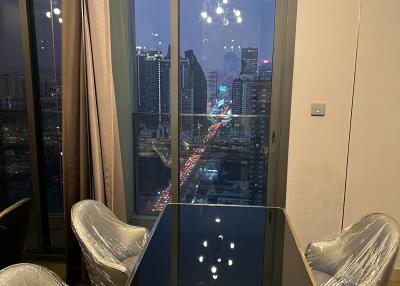 Modern dining room with cityscape view through large windows at night