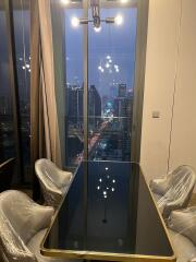 Modern dining room with cityscape view through large windows at night