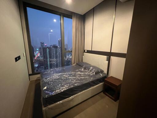 Modern bedroom with a city view at night