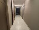 Modern hallway with marble flooring and recessed lighting