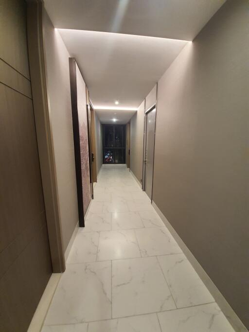 Modern hallway with marble flooring and recessed lighting