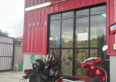 Exterior view of a commercial building with large windows and motorcycles parked in front