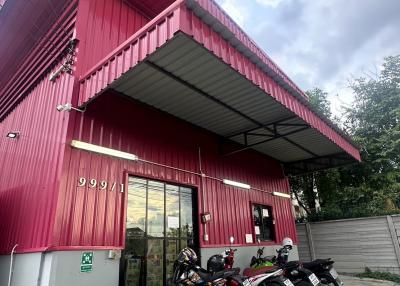 Red commercial building exterior with parking space