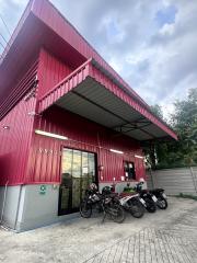 Red commercial building exterior with parking space