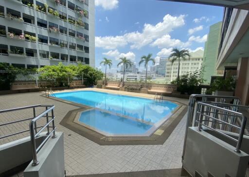 Swimming pool area with city view in a residential building complex