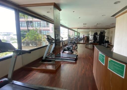 Spacious gym area with modern equipment and large windows