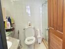 Bright bathroom with white tiles and wooden accents