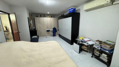Spacious bedroom with a large bed and modern air conditioning unit