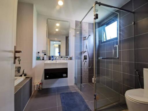 Modern bathroom with glass shower and stylish tiling