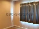 Empty bedroom with hardwood floor and curtains