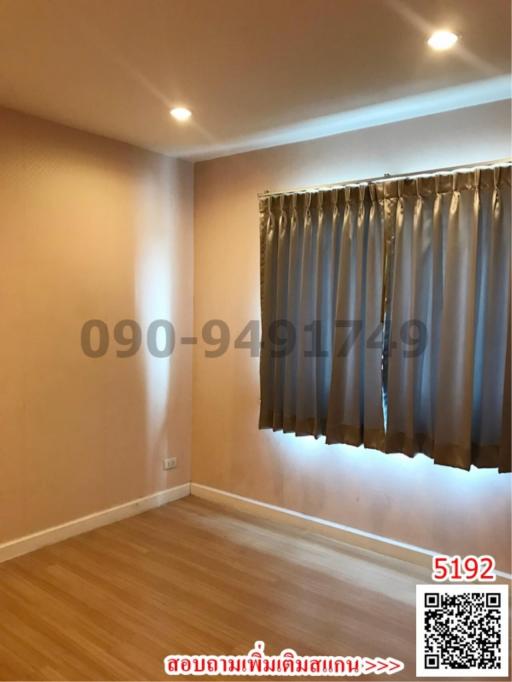 Empty bedroom with hardwood floor and curtains