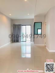 Spacious and well-lit empty room interior with reflective floor and balcony access